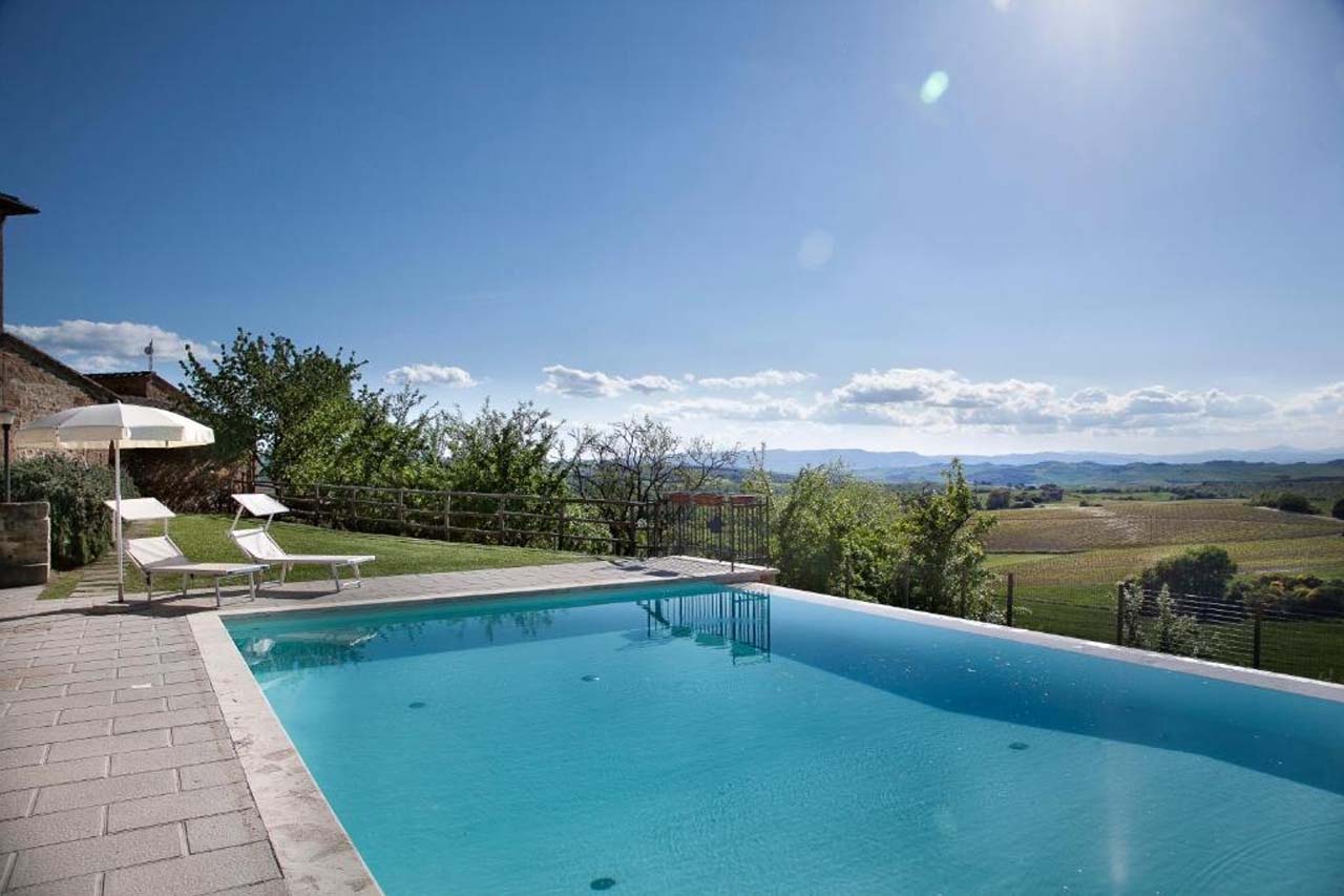 Large outdoor pool with a stunning view of the landscape in Agriturismo Palazzo Massaini