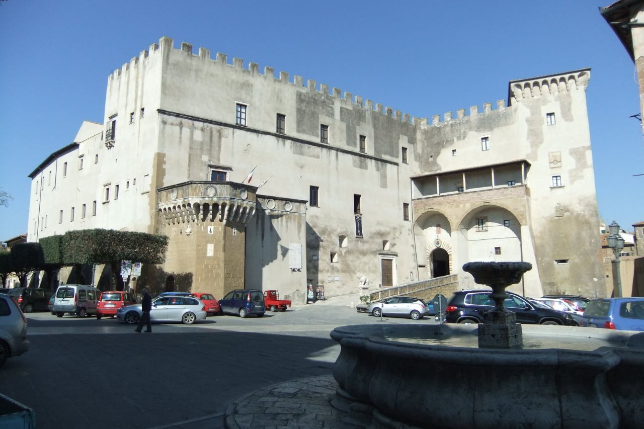 Tourists are entering the Orsini palace, in Pitigliano