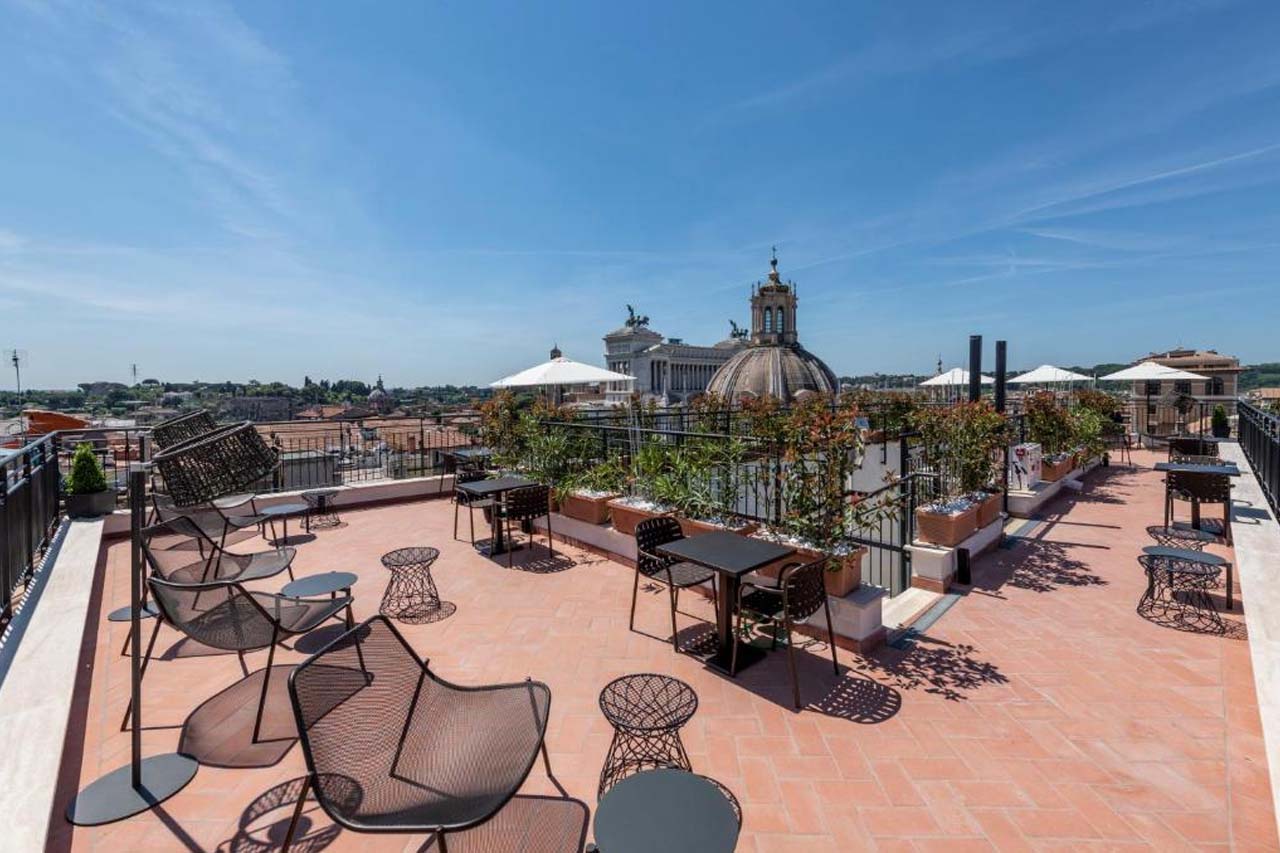 Dining area on the rooftop with an overlooking the church in H10 Palazzo Galla