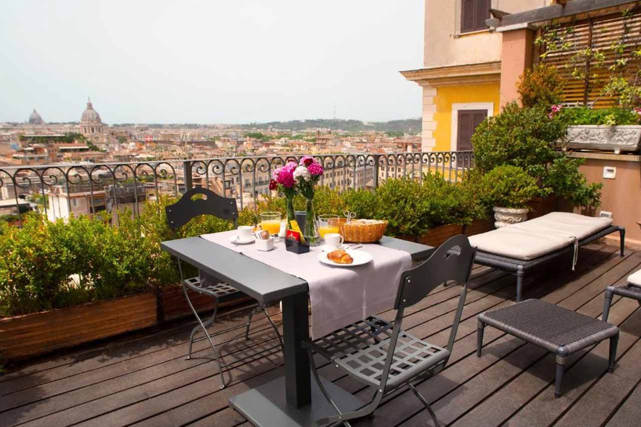 Dining area on the rooftop with a stunning view of the city in Hotel Scalinata Di Spagna, Rome, Italy