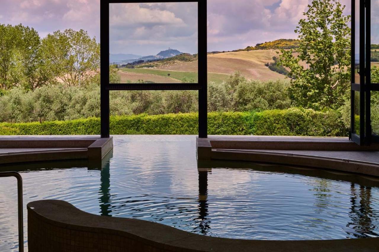 Indoor pool with overlooking view of beautiful landscape in the Fonteverde Lifestyle & Thermal Retreat