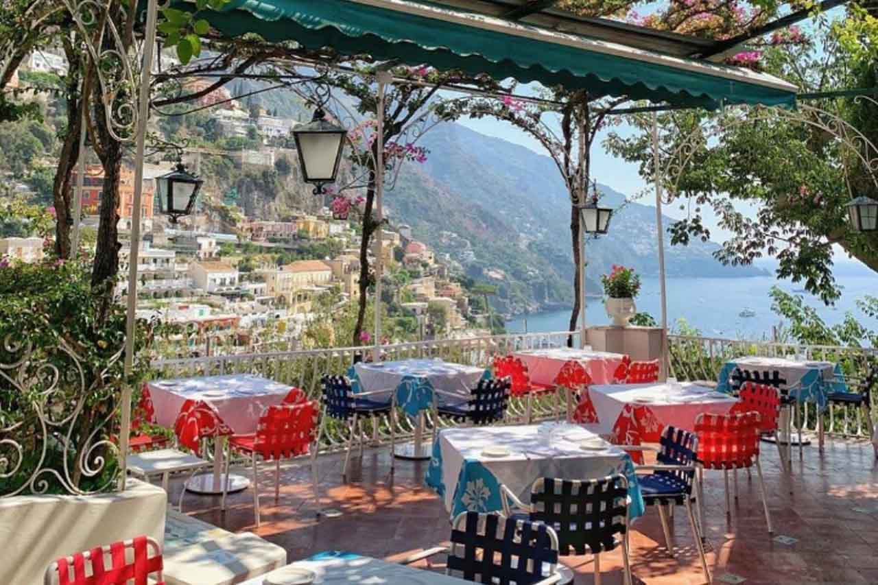 Stunning view of the sea and mountain from dining area in Il Tridente Positano